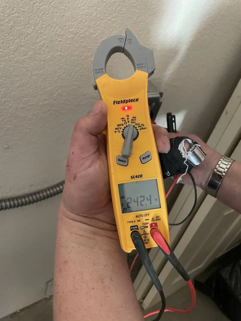Voltage testing with clamp meter during Outlet Installation in Granger